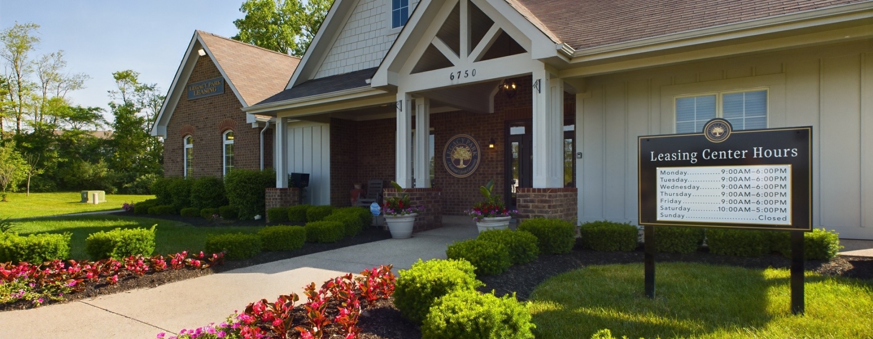 Your Gateway to Exceptional Living: Your Premier Leasing Destination building photo with sidewalk and front doors