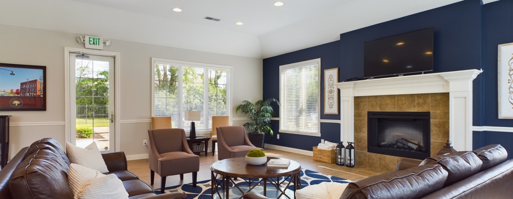 photo of clubroom with seating and fireplace