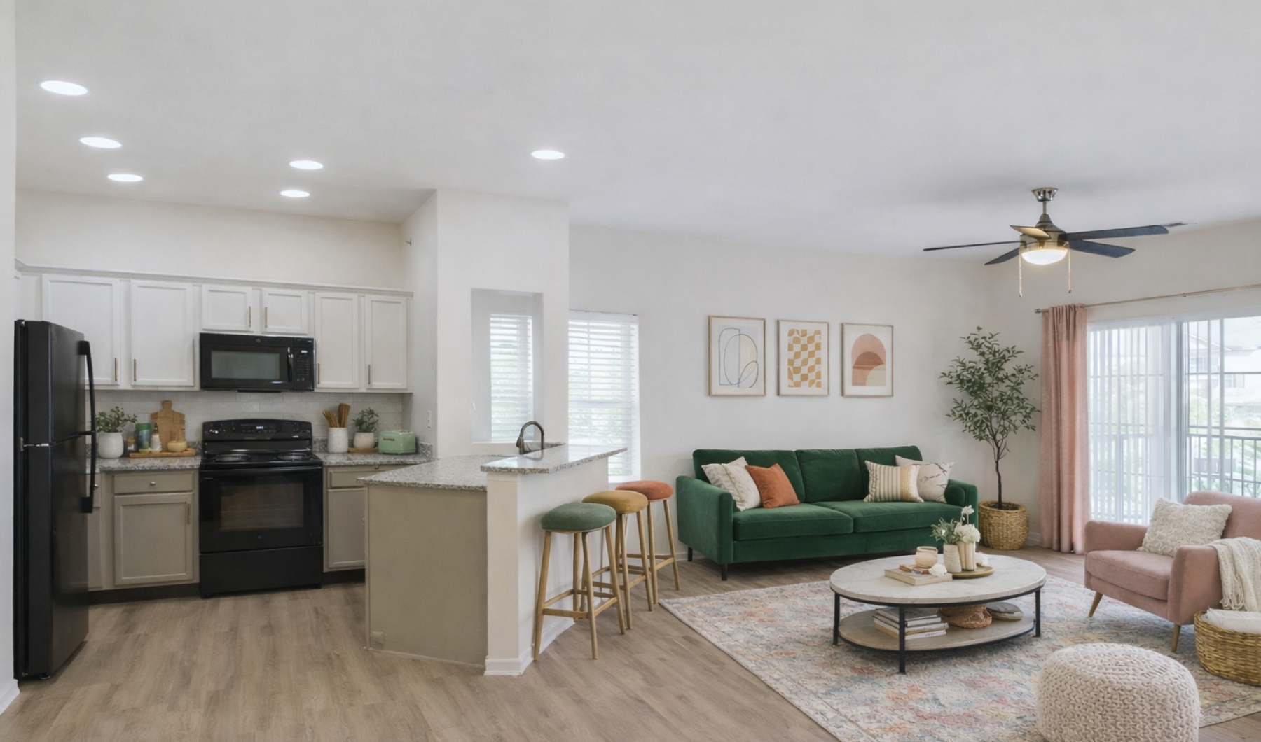 Staged living room and kitchen with green and pink accents