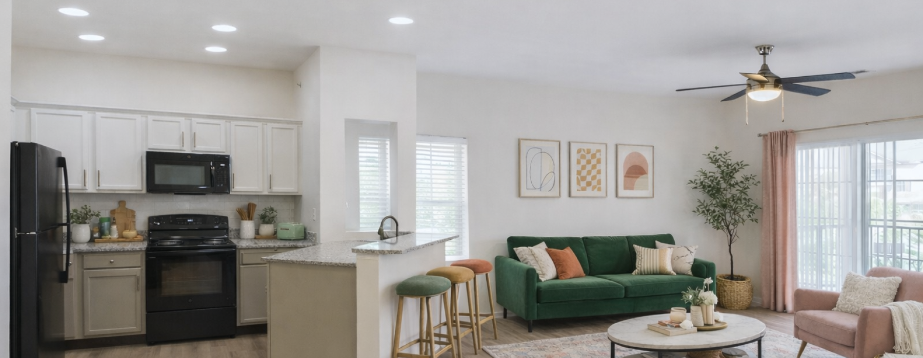 Staged living room and kitchen with green and pink accents