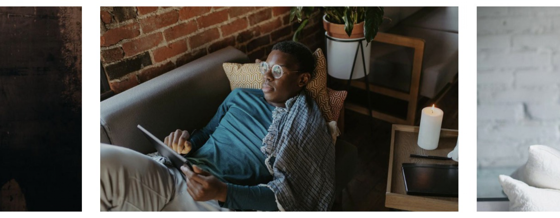 a guy on a tablet laying on the couch